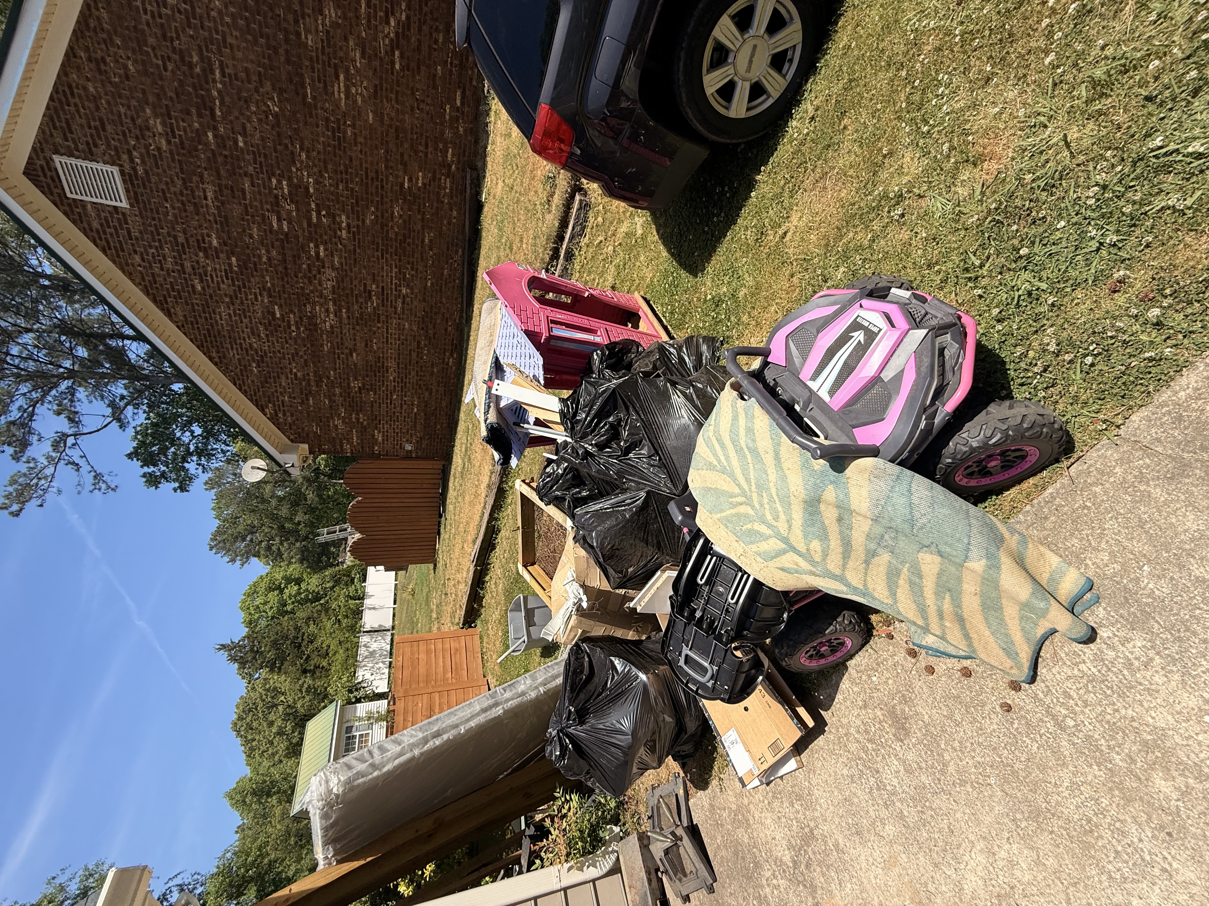 Large junk pile at a residential property before removal