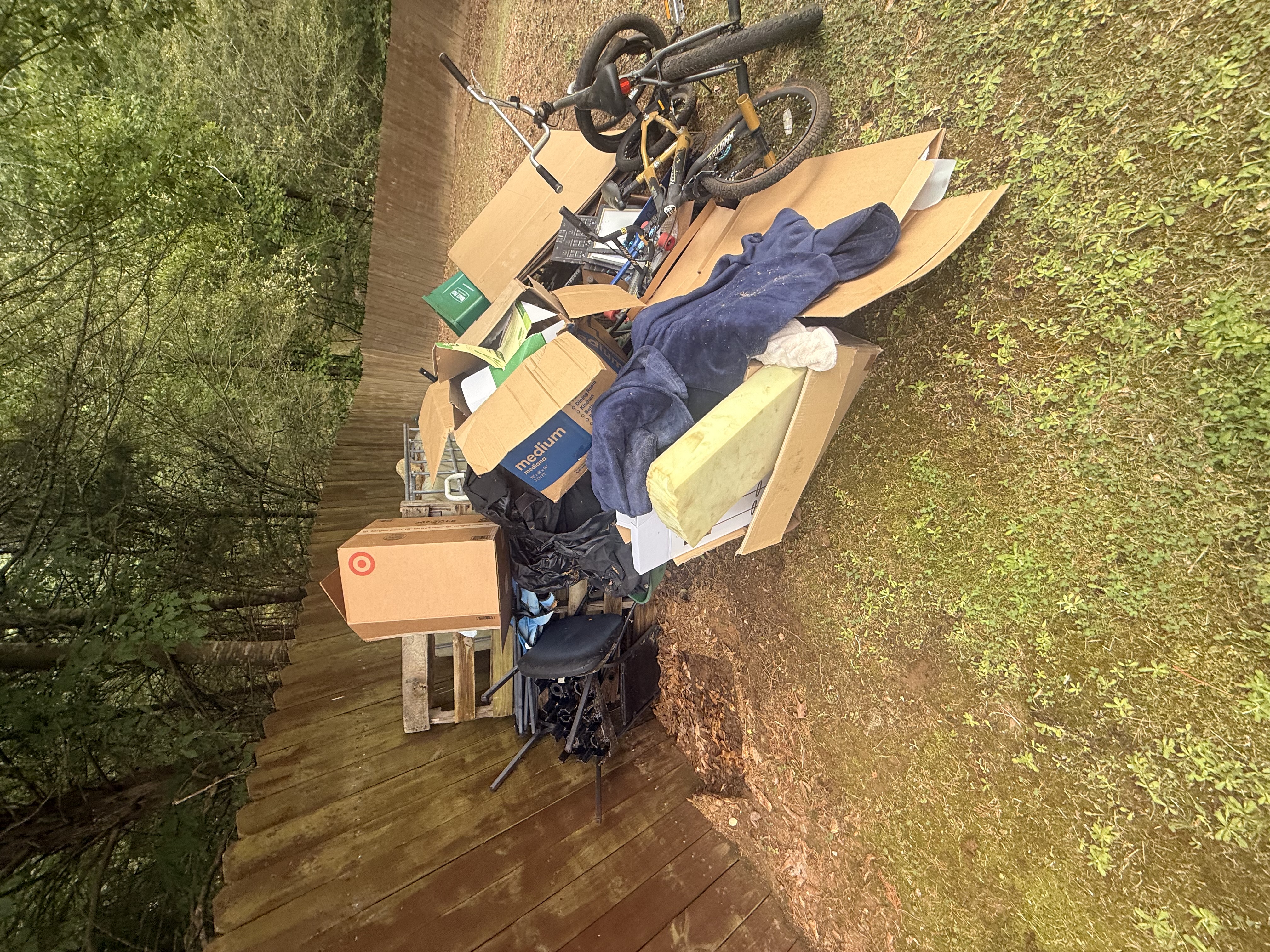 Junk and clutter piled on a back deck before cleanout