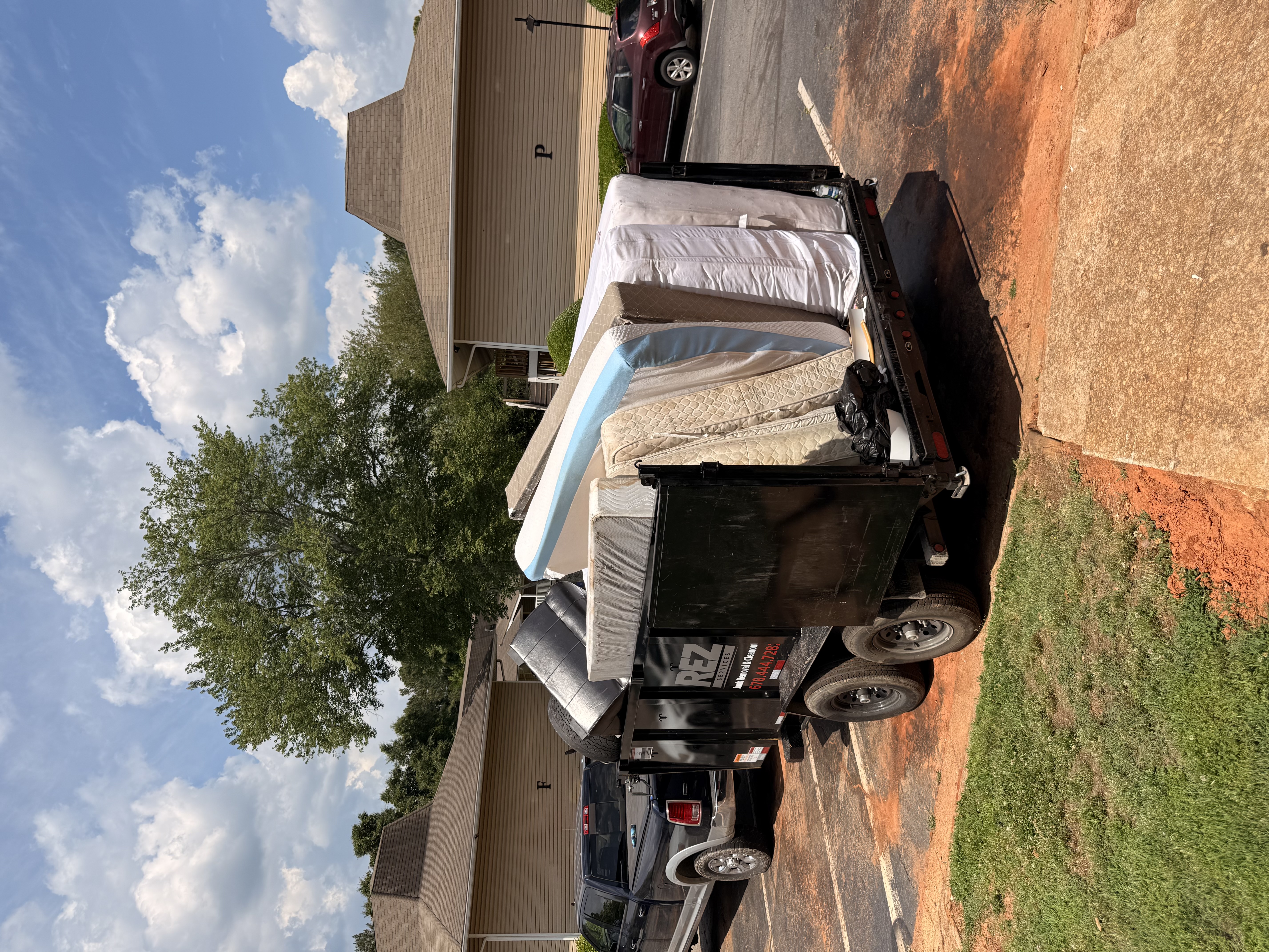 REZ trailer loaded with mattresses for removal