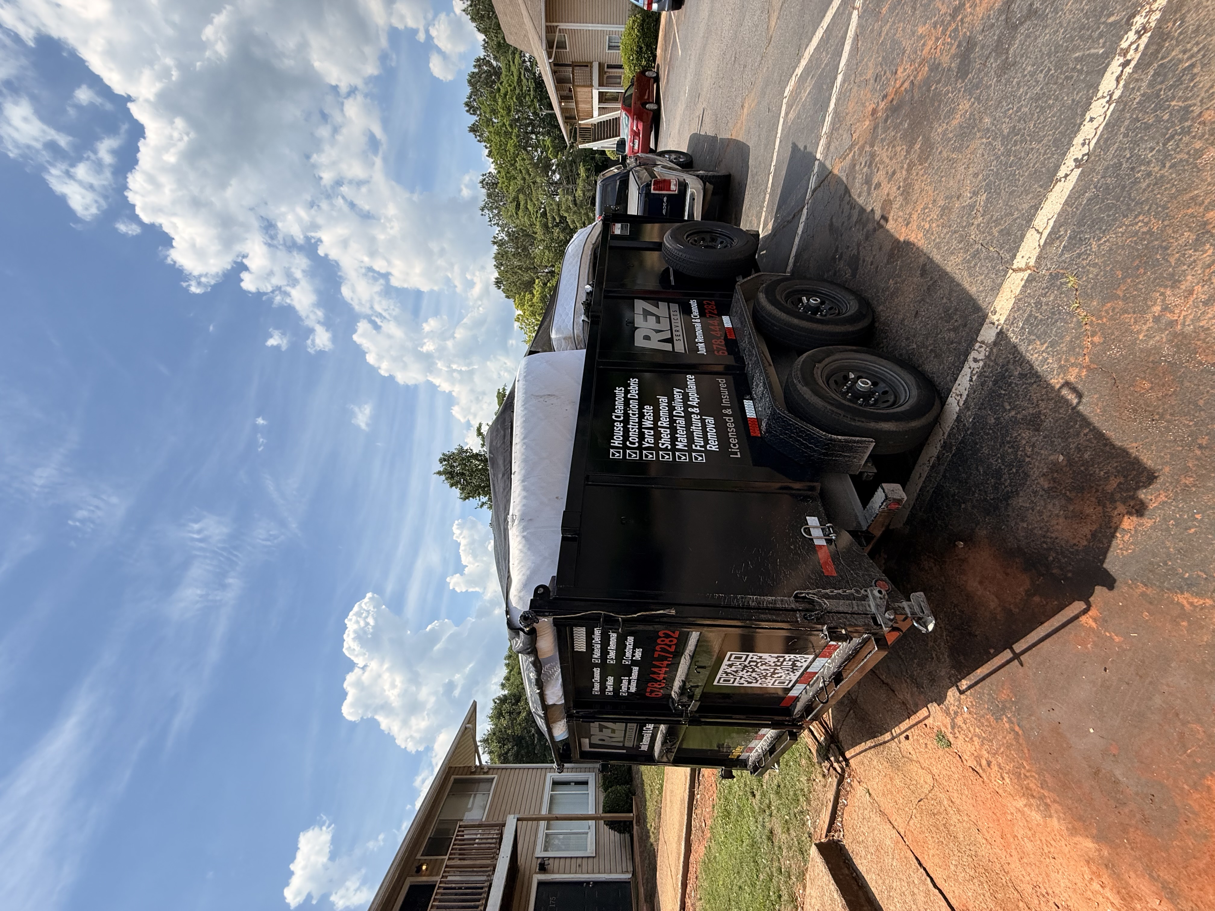 REZ Services trailer at an apartment complex job