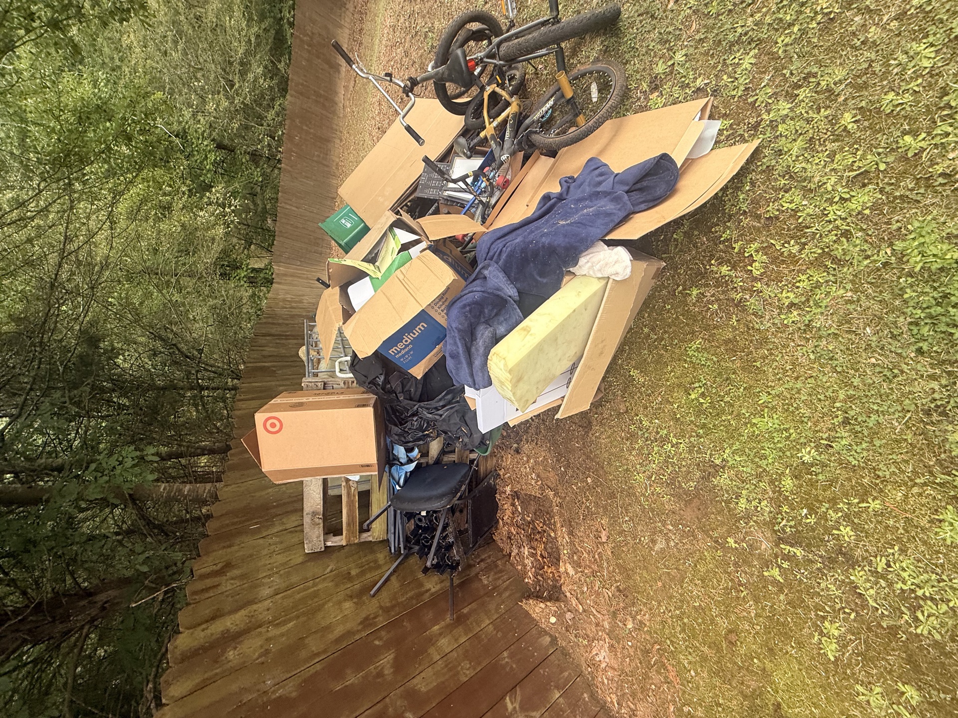 Junk and clutter piled on a back deck before cleanout