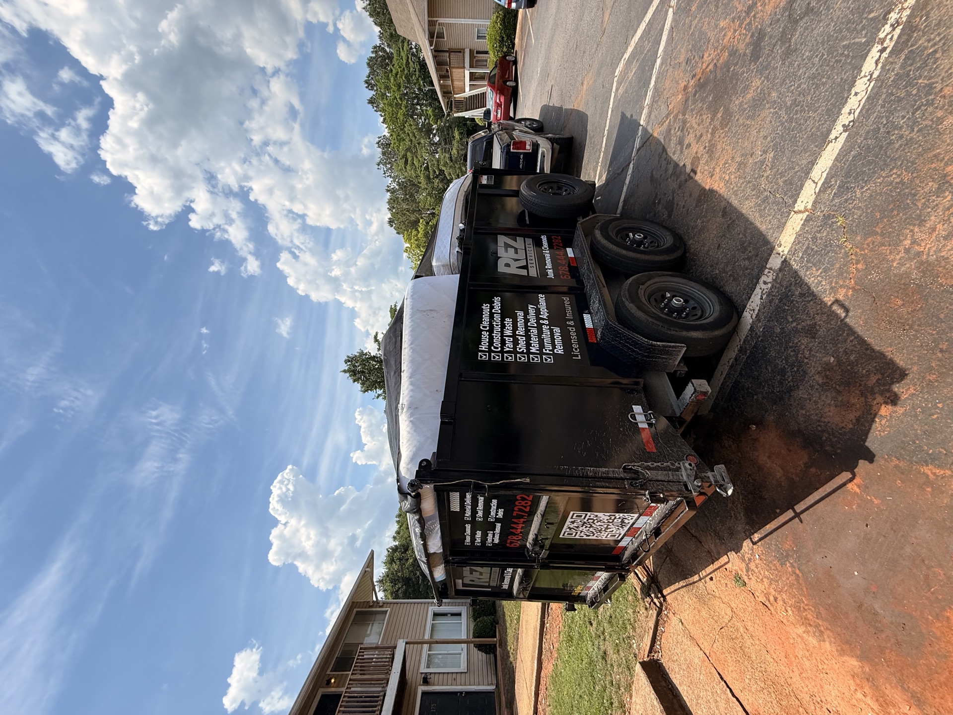 REZ Services trailer at an apartment complex job