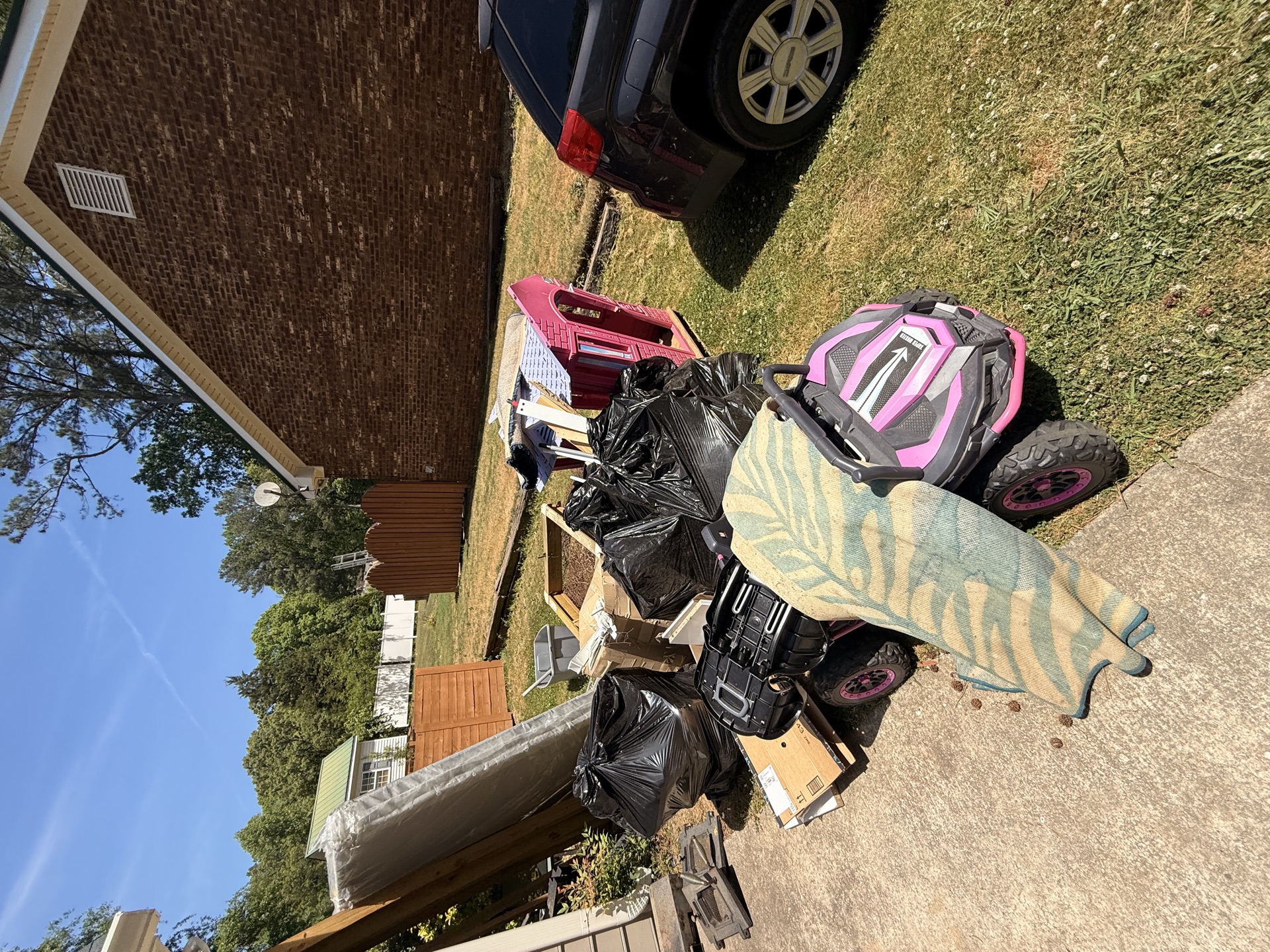 Large junk pile at a residential property before removal